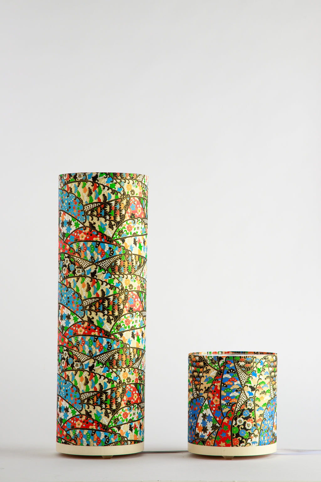 Branstead Design canvas table lamps in tall and short sizes, unlit, showing colorful festival rhythmic fan-patterned textile design