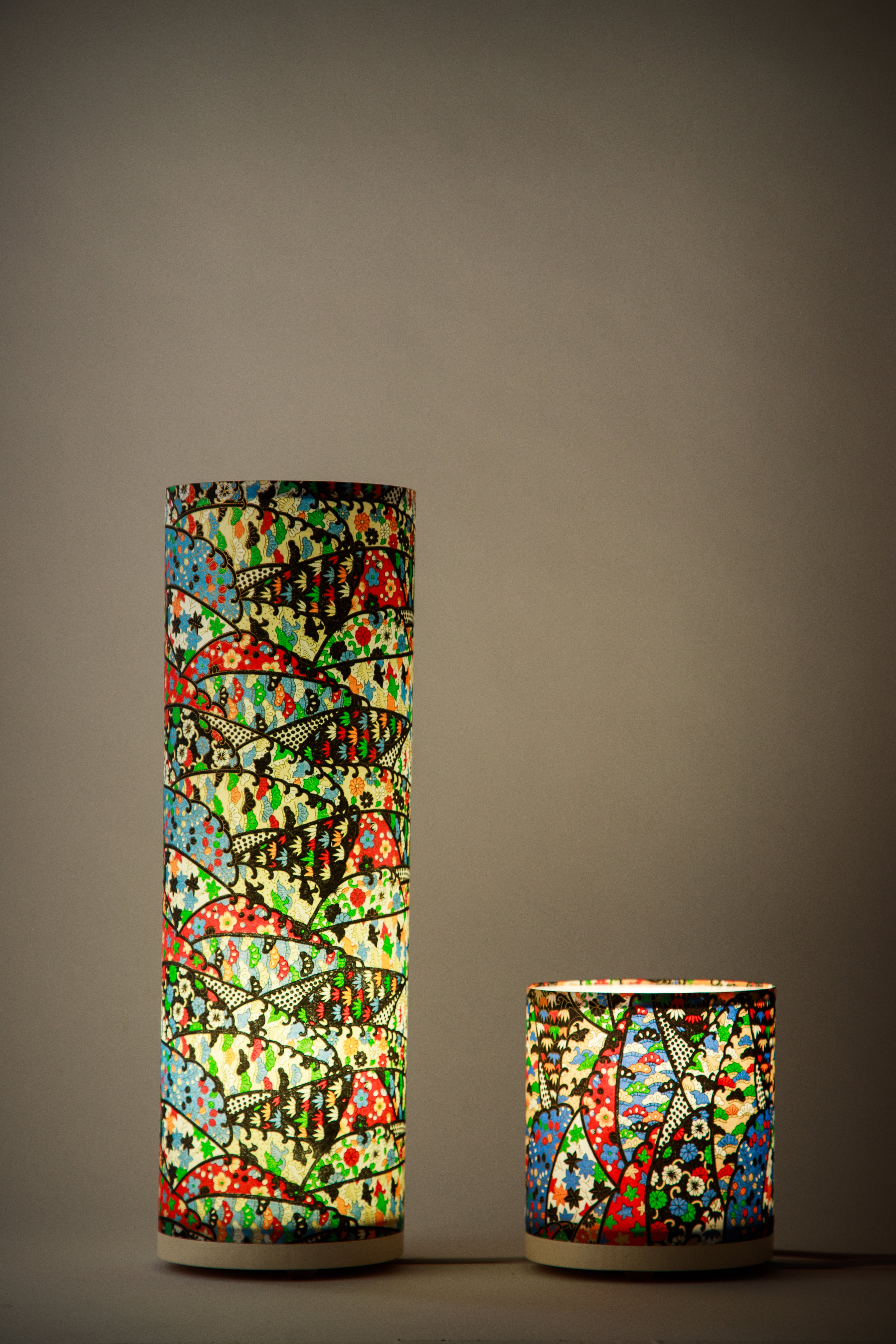 Branstead Design custom-made canvas lamps lit, made of Japanese paper, casting a warm glow through repeating geometric fan motifs