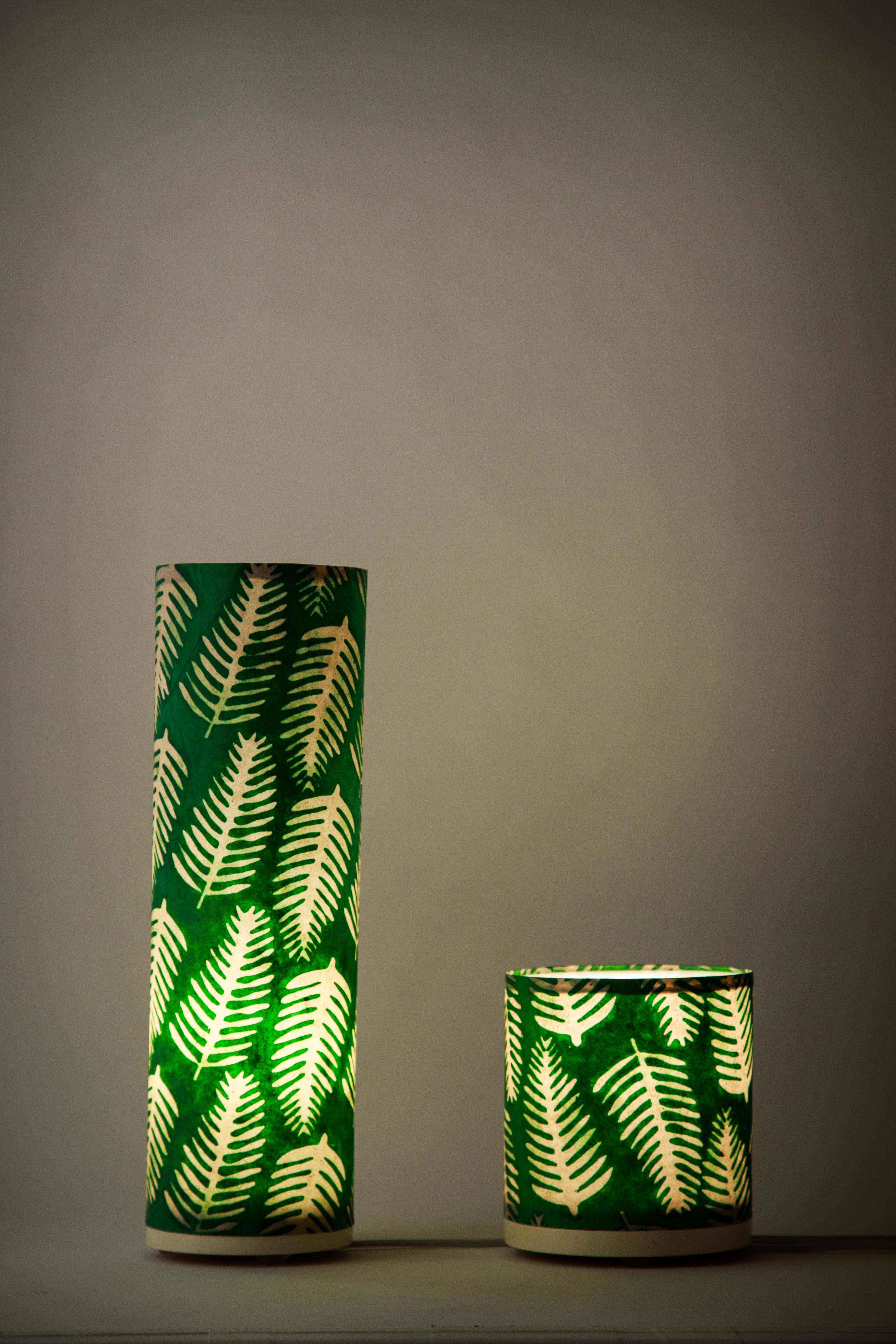 Handmade paper lamp featuring repeating fern silhouettes in natural green tones