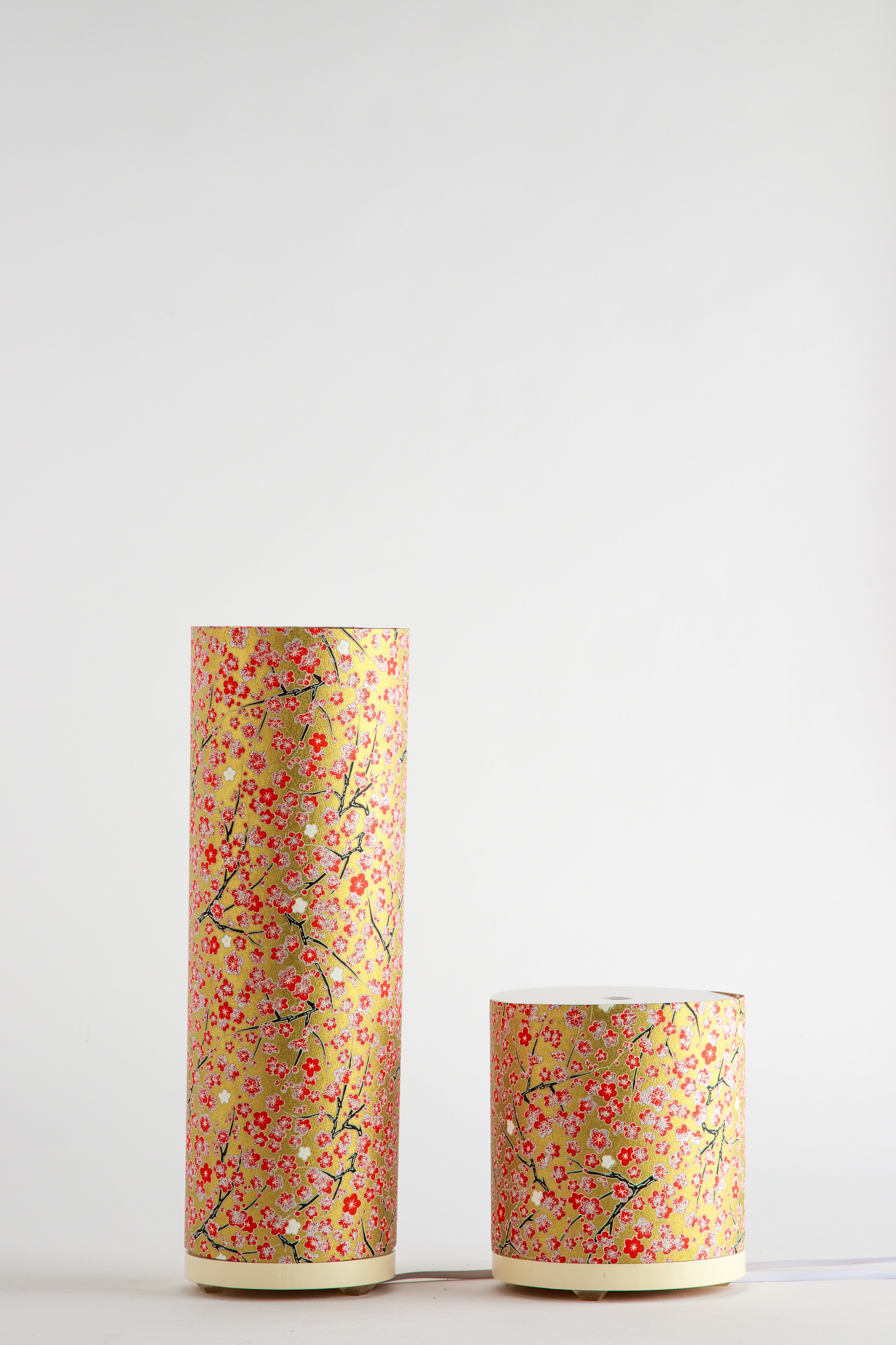 Tall and short cylindrical Japanese cherry blossom custom artistic bedside lamps with red floral branch pattern on golden paper, made by Branstead Design