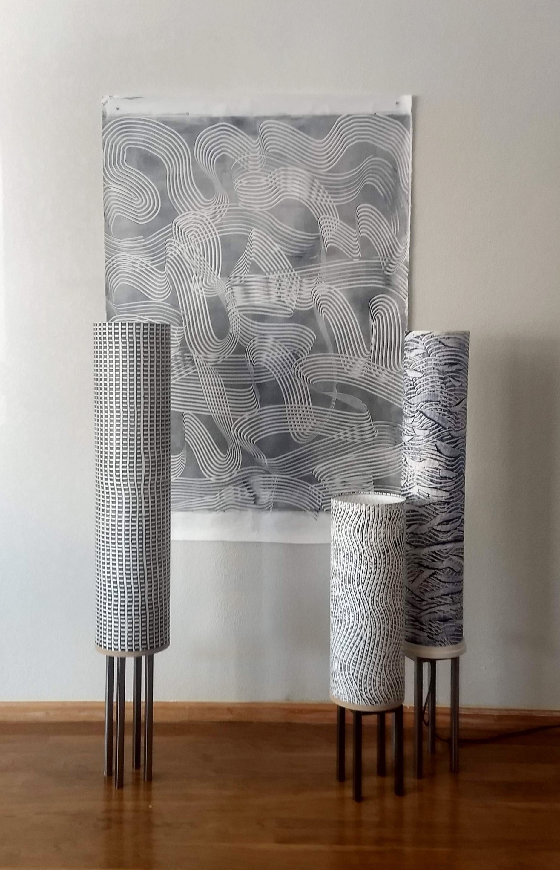 Beautiful custom-made grey floor lamps by Patricia Branstead arranged with abstract gray artwork.
