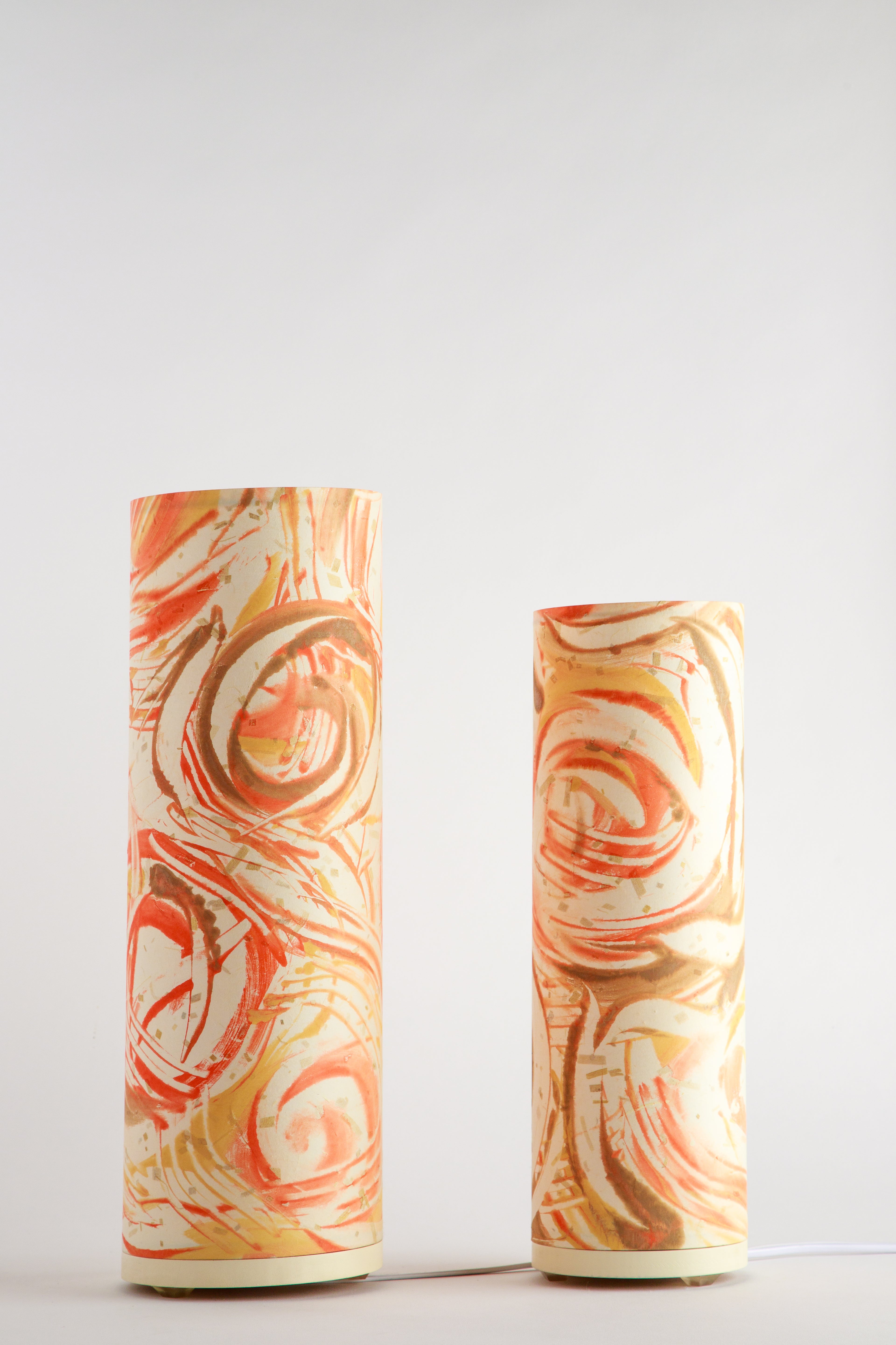 Hand-painted canvas table lamp with swirling rust, amber, and cream tones on a white background