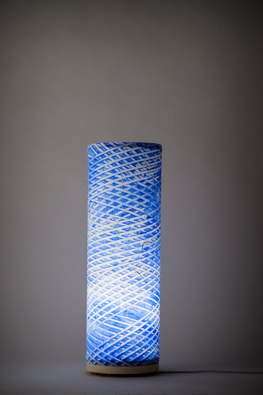 Hand-painted cobalt blue canvas table lamp painted by Patricia Branstead with diagonal helix pattern, cylindrical modern studio lamp from the Strata collection