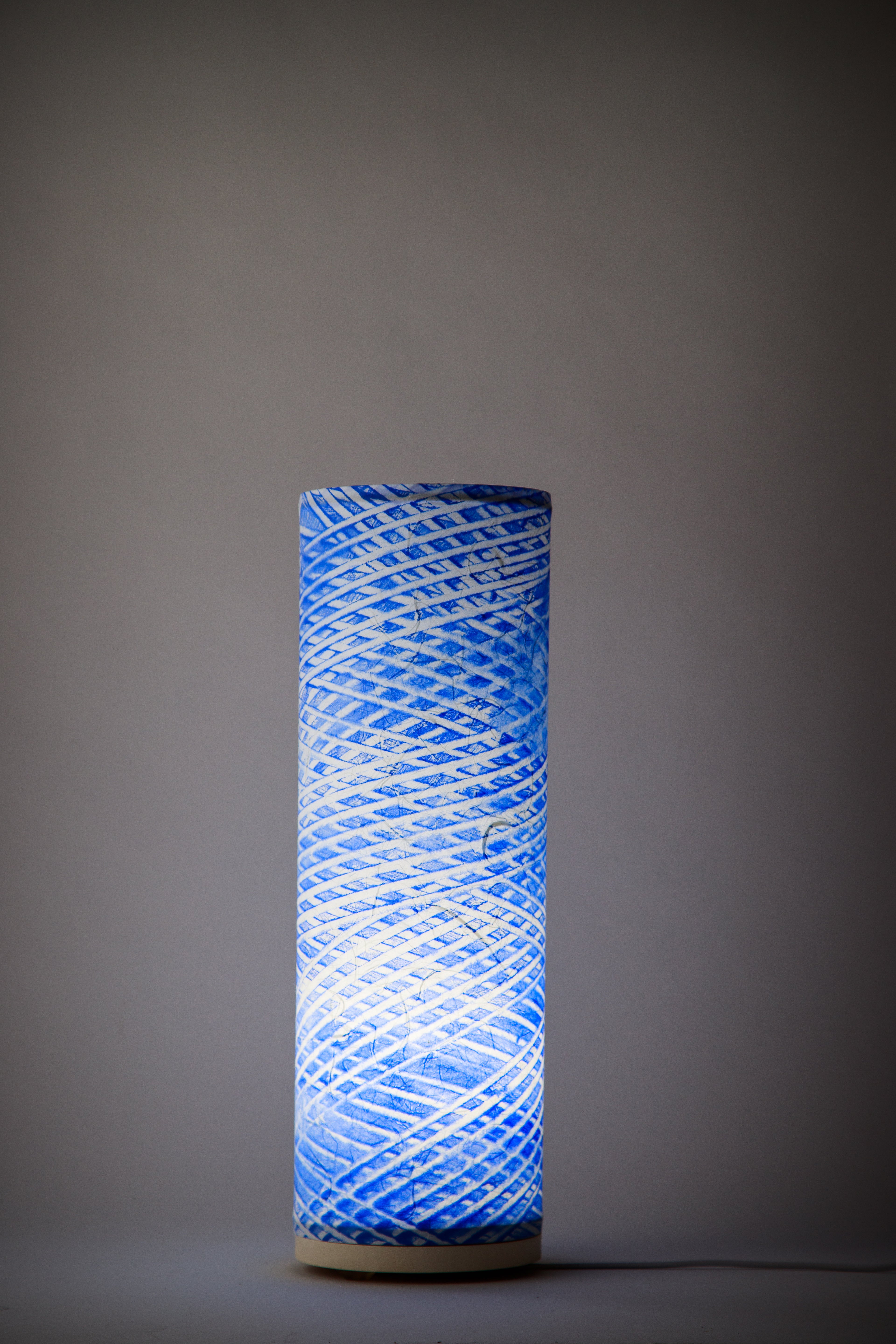 Hand-painted cobalt blue canvas table lamp painted by Patricia Branstead with diagonal helix pattern, cylindrical modern studio lamp from the Strata collection