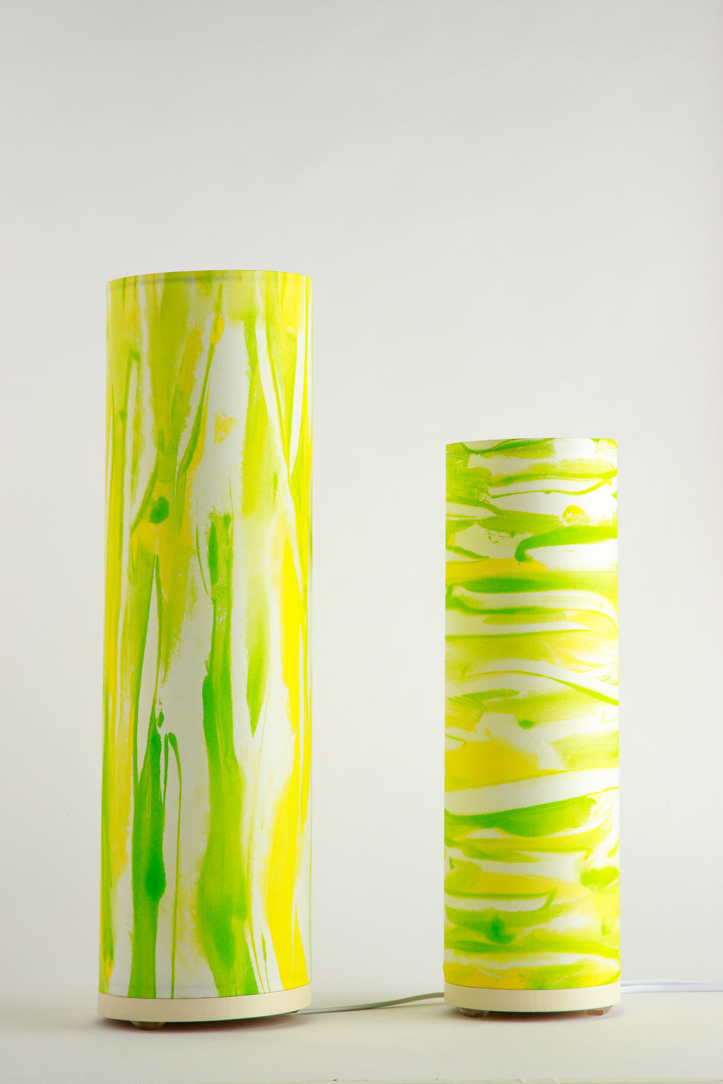 Handcrafted modern table lamp by Patricia Branstead with flowing lime green and yellow brushstrokes on a white background, Flux – Sunlit Spring unlit
